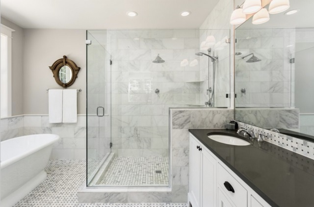 bathroom with glass enclosures