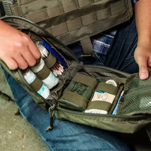 a man holding a molle tactical pouch