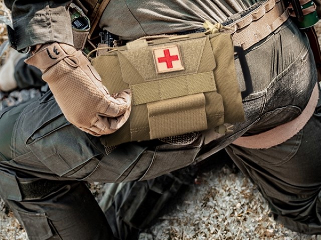 a molle medical pouch attached to a soldiers belt